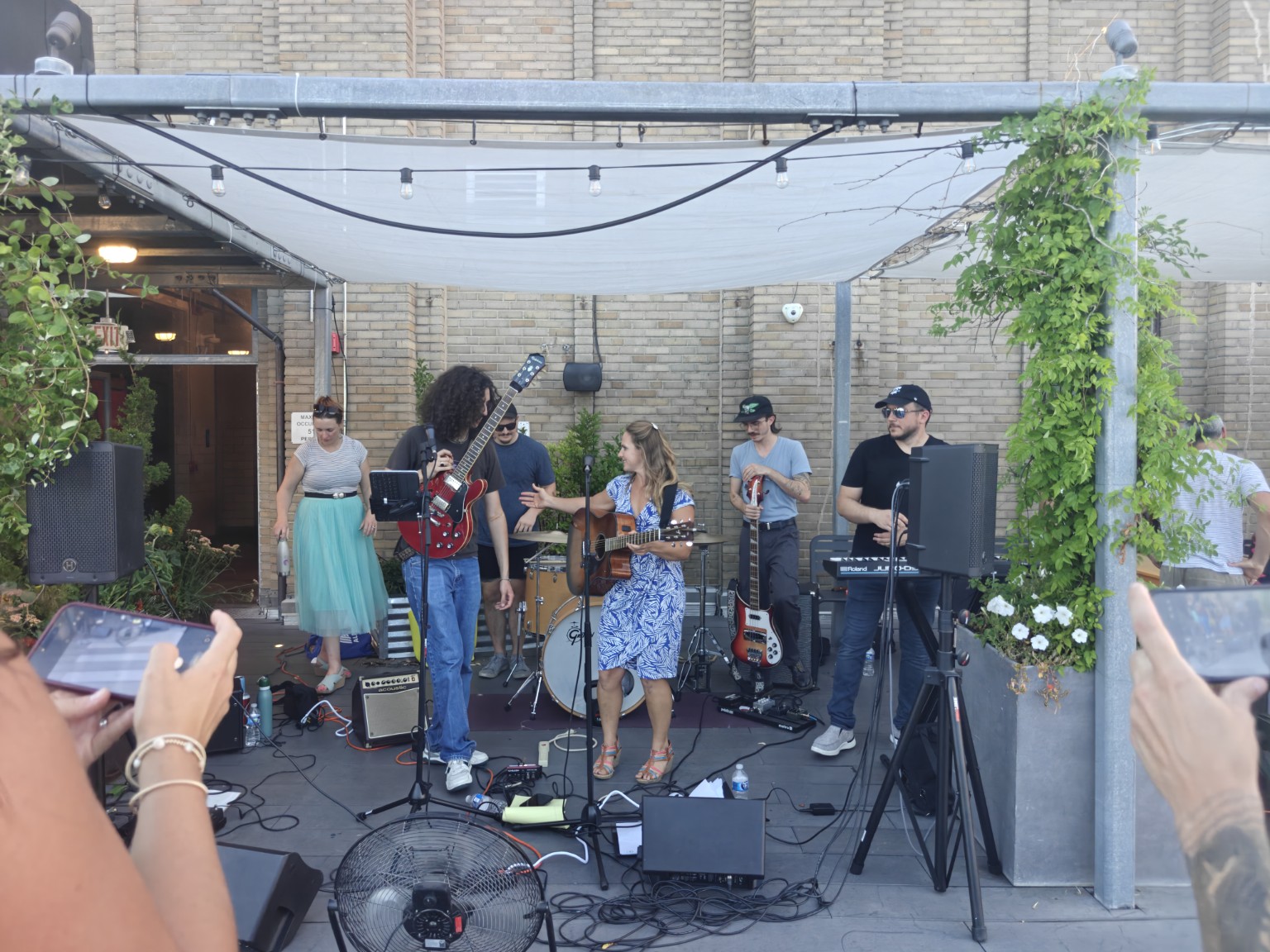 Katie and The Undertow performing together on an outdoor stage